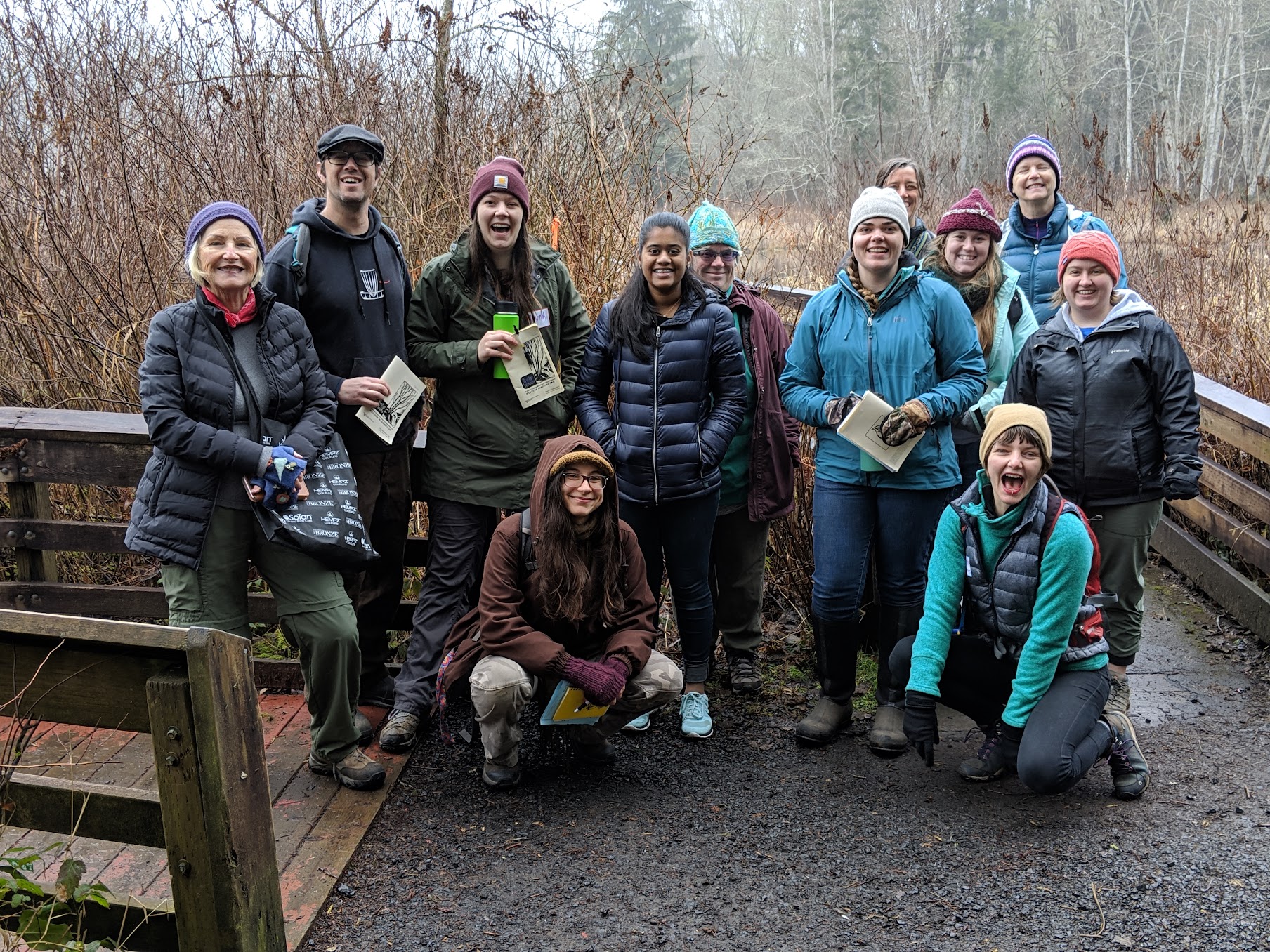 Group of happy people studying winter twigs